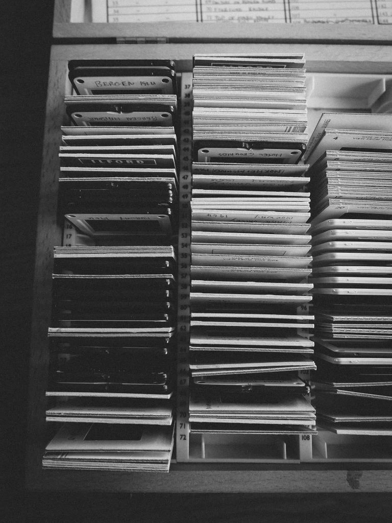 Archival mat cutter trimming a museum-grade mat around a black-and-white print