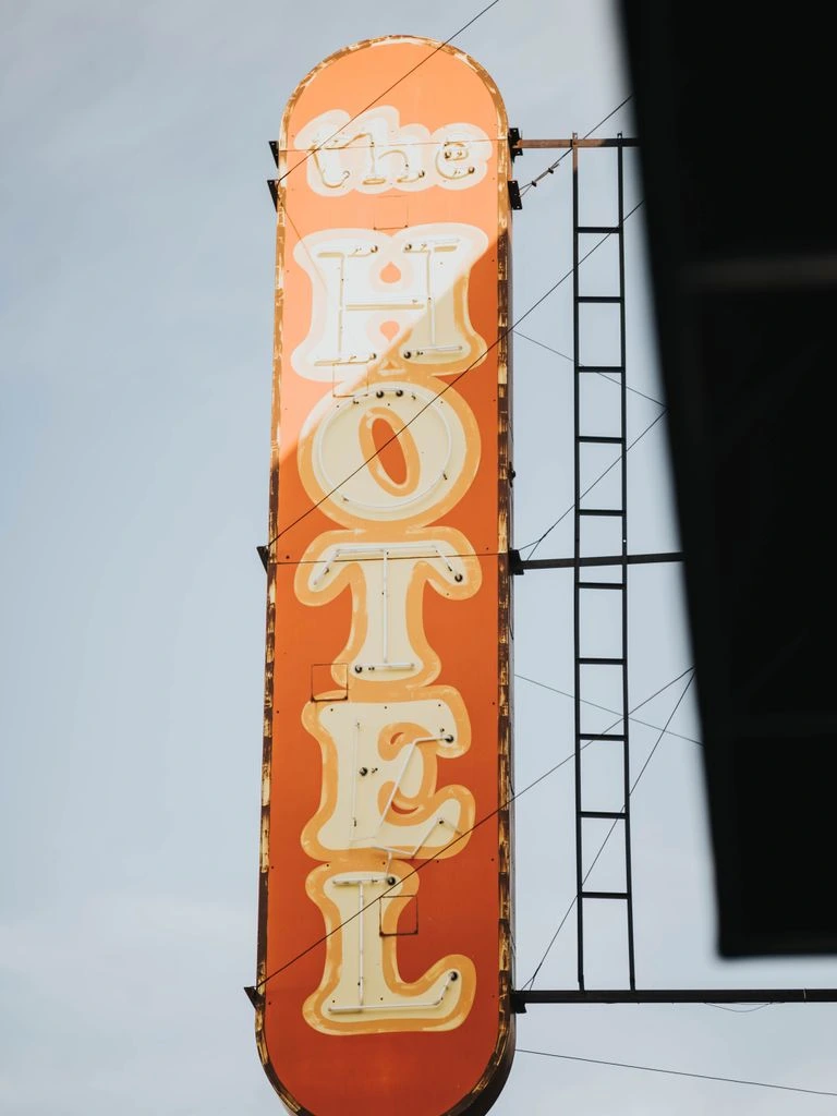 A pigment print of an empty motel courtyard at golden hour